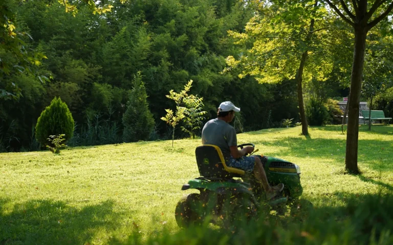 A well-kept robot mower parked on a healthy green lawn after several years of reliable use