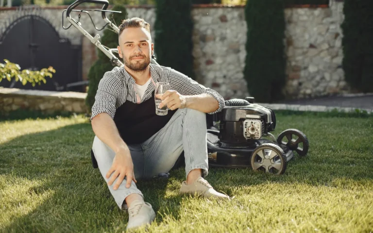 A robot lawn mower running across a neatly cut green lawn on a sunny afternoon