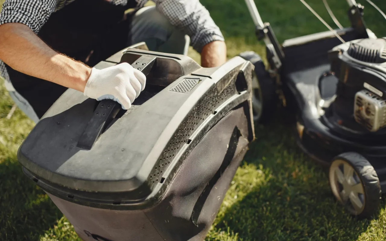 Robot mower on a workbench surrounded by tools during an annual service inspection