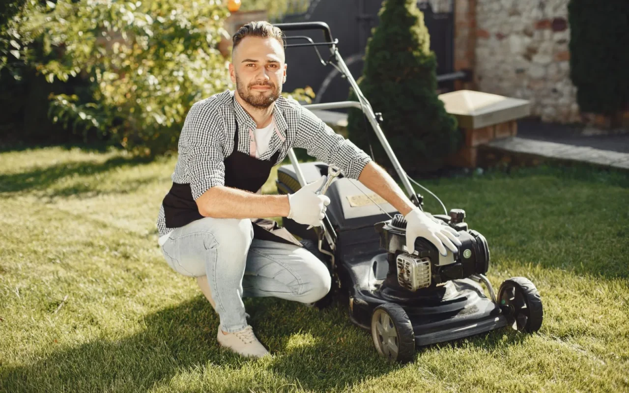 Close-up of a robot mower flipped over showing small razor cutting blades on a disc