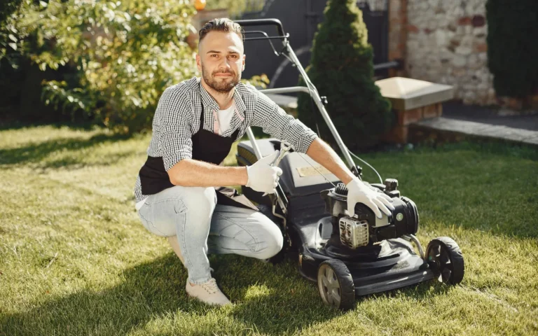 Close-up of a robot mower flipped over showing small razor cutting blades on a disc
