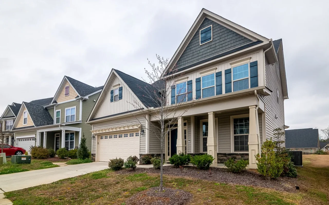 Home garden with a green lawn where a homeowner is weighing robot mower payment options