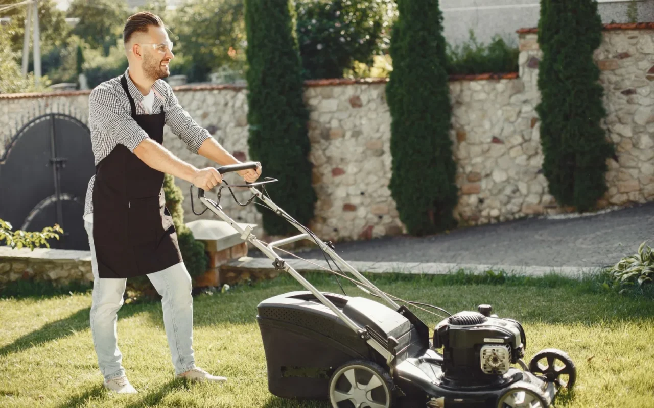 New robot lawn mower leaving its charging dock onto a green lawn for the first time