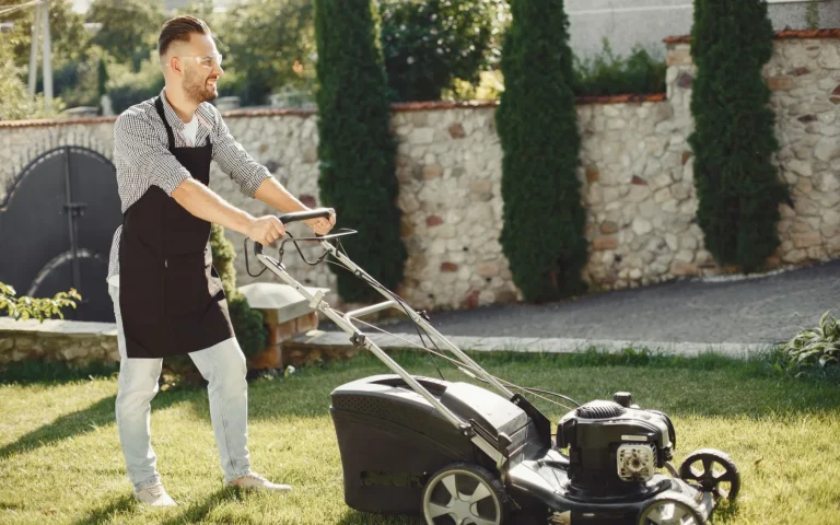 New robot lawn mower leaving its charging dock onto a green lawn for the first time