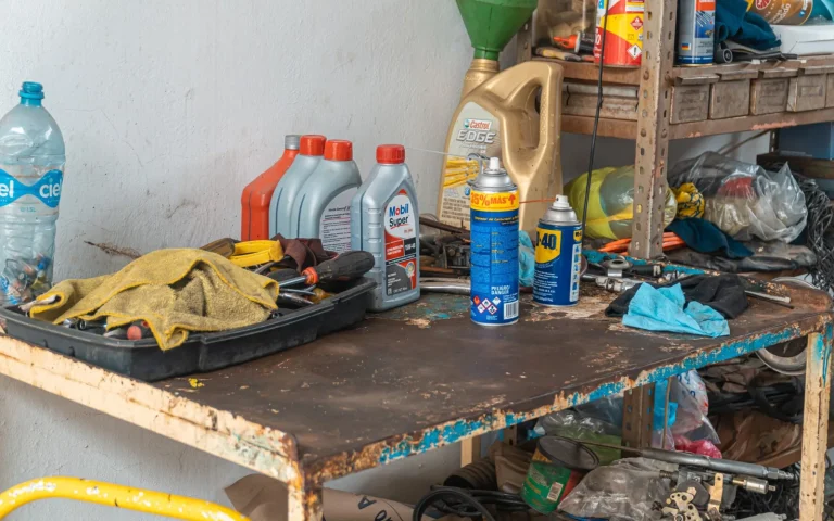 Robot mower parts, blades, and tools laid out on a table for maintenance budgeting