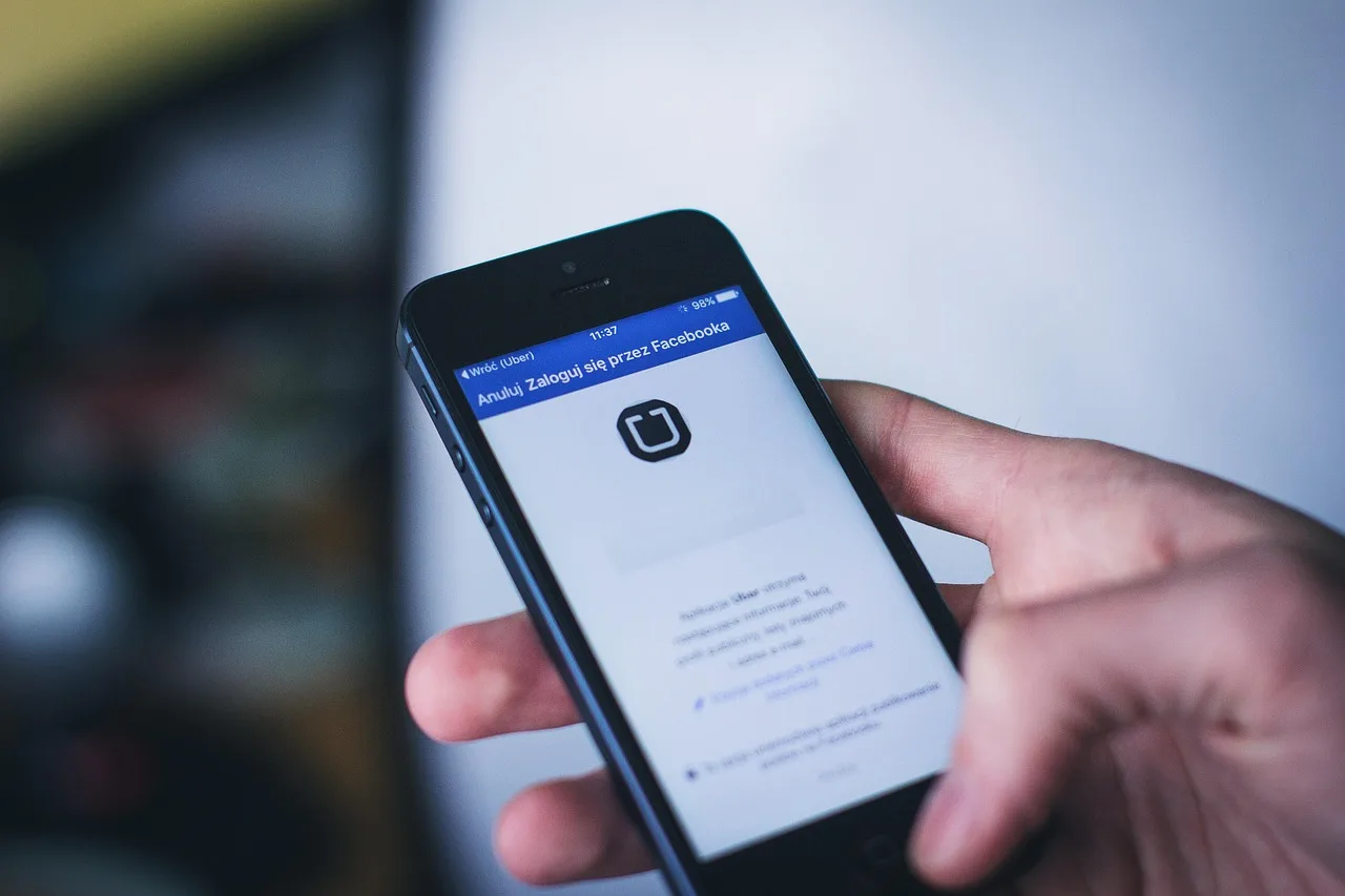 Hand entering a secure password on a phone app login screen