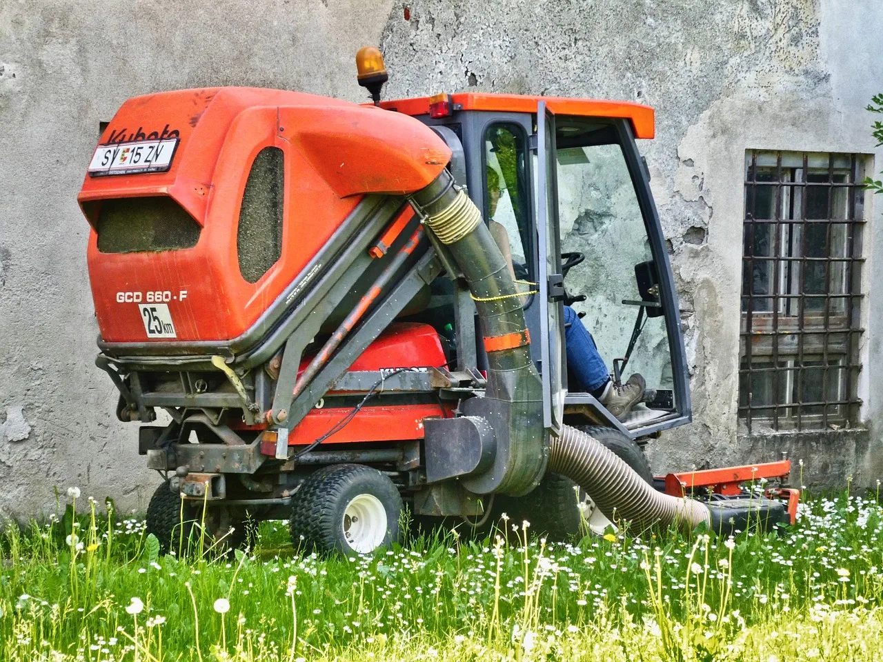 Robot mower parked in a suburban garden at dusk with anti-theft protection