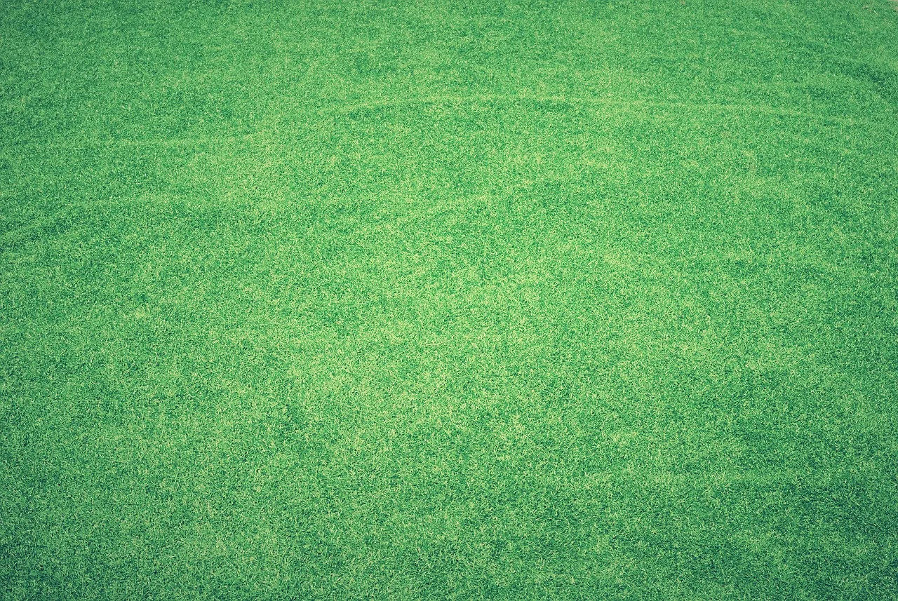 An RTK GPS reference antenna mounted on a post beside a large lawn