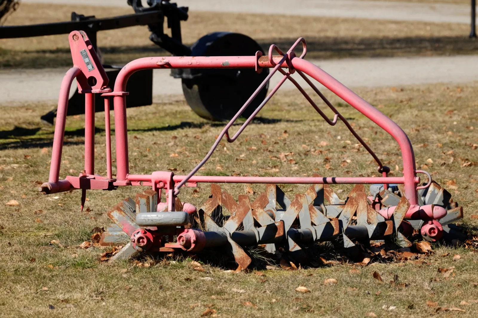Close-up of a robot mower blade disc with small razor blades and grass buildup