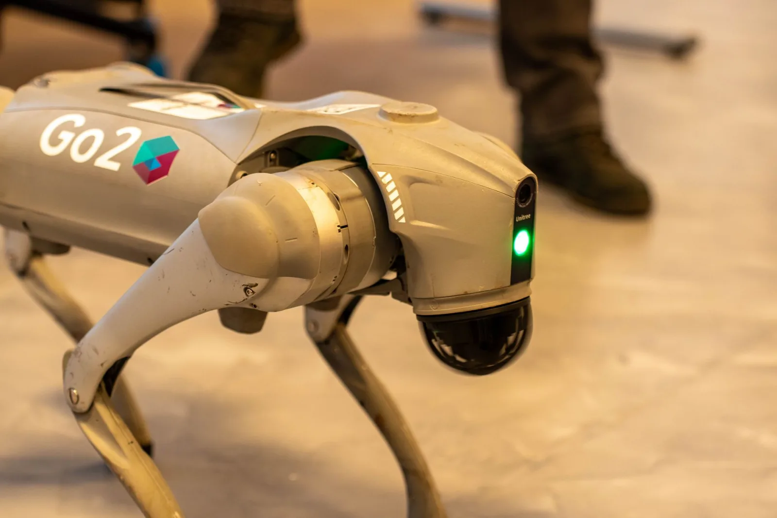 Soft cloth wiping a navigation sensor on the shell of a robot lawn mower