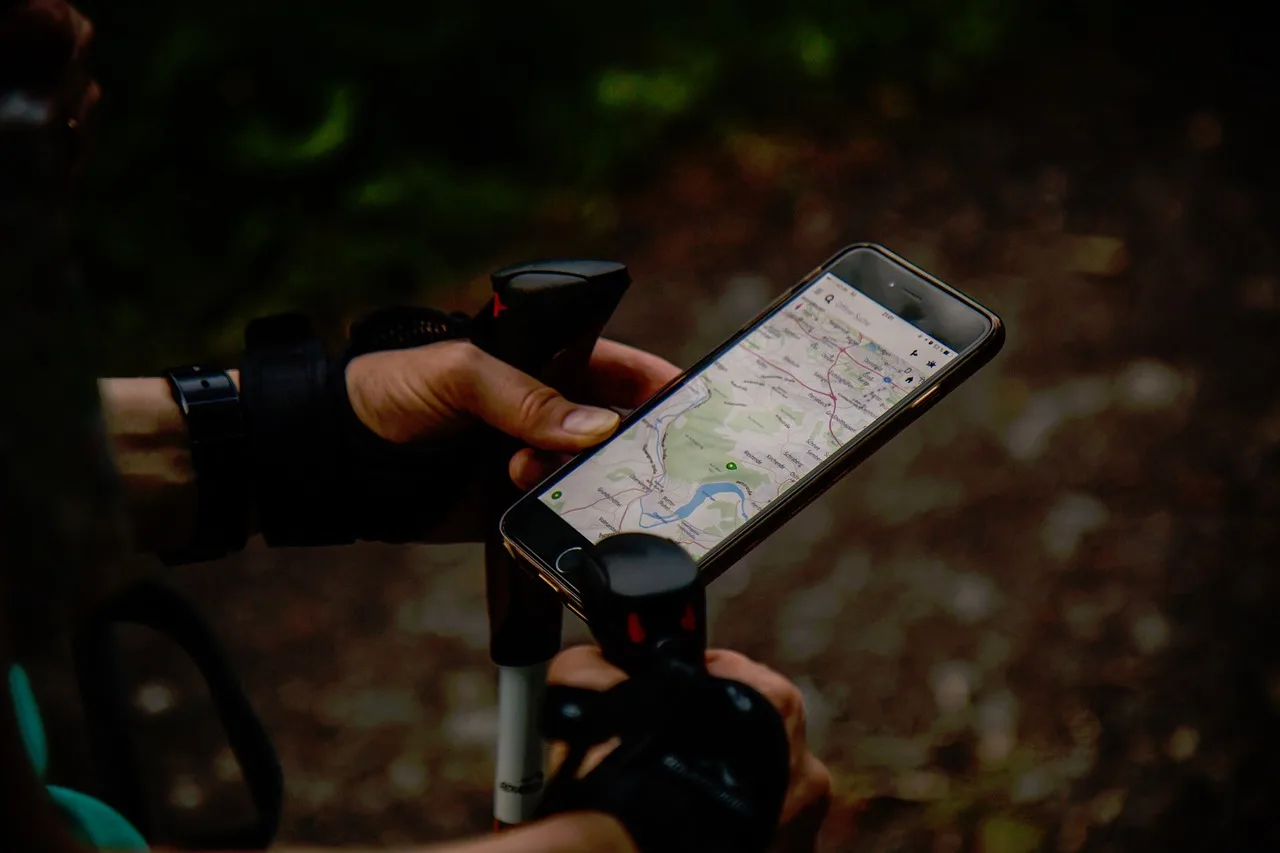 Smartphone displaying a location map used to track a robot mower
