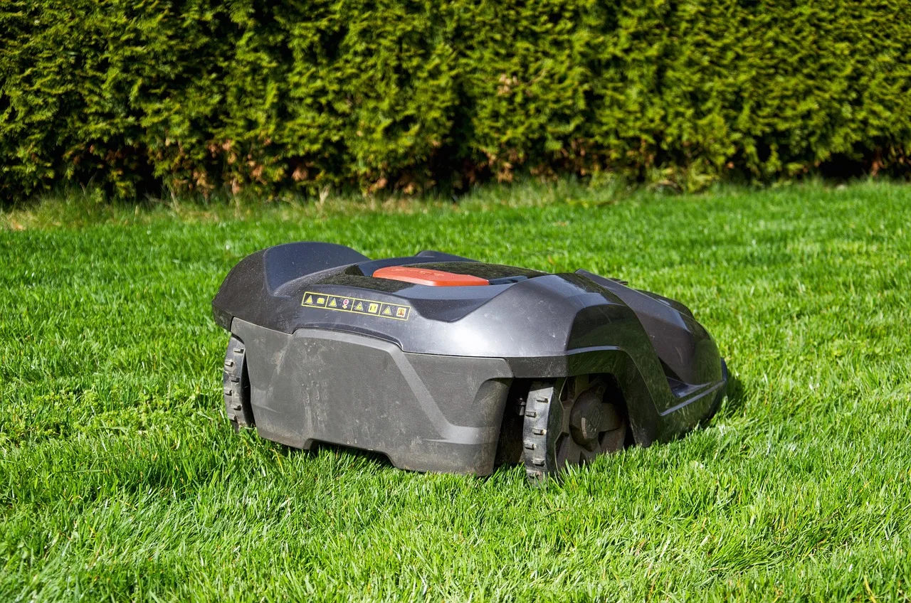 Robot mower charging station with a guide wire running out across the lawn