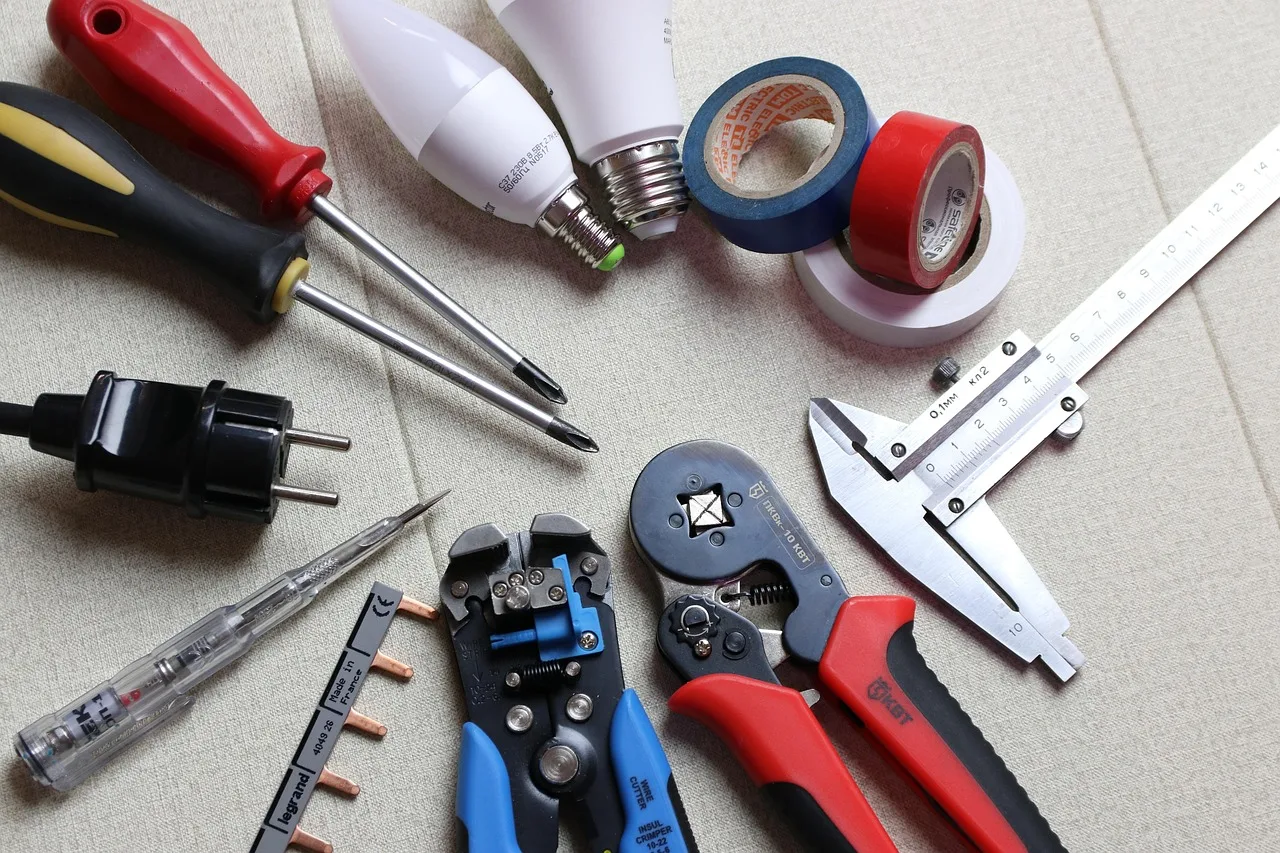 Screwdriver removing a small blade screw from an upturned robot lawn mower