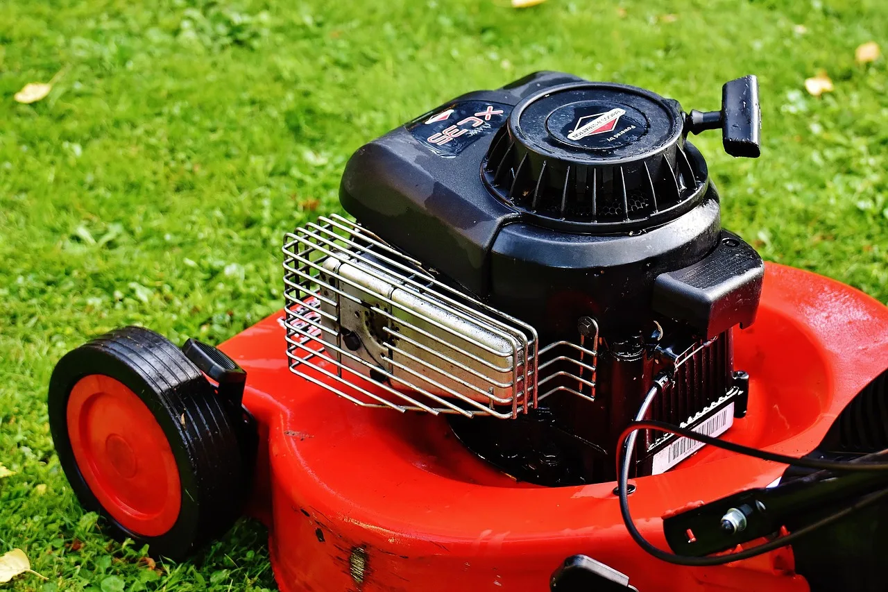 Robot mower running across a sunlit lawn during a scheduled afternoon session
