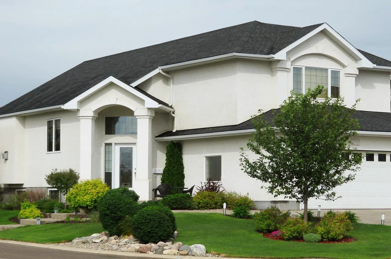 An overhead satellite style view of a suburban home and its green lawn