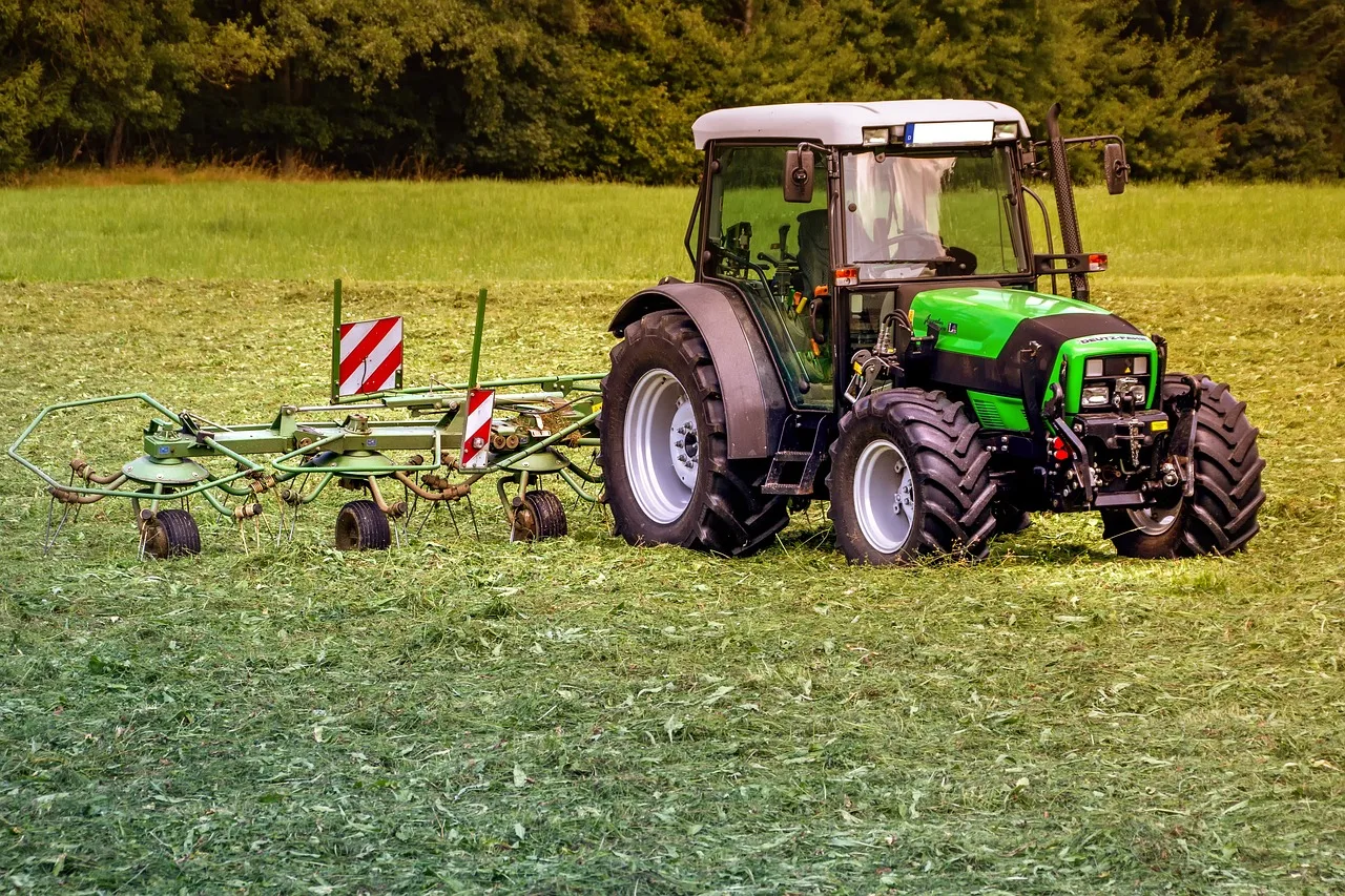 A robot lawn mower working across a gently sloped section of green lawn