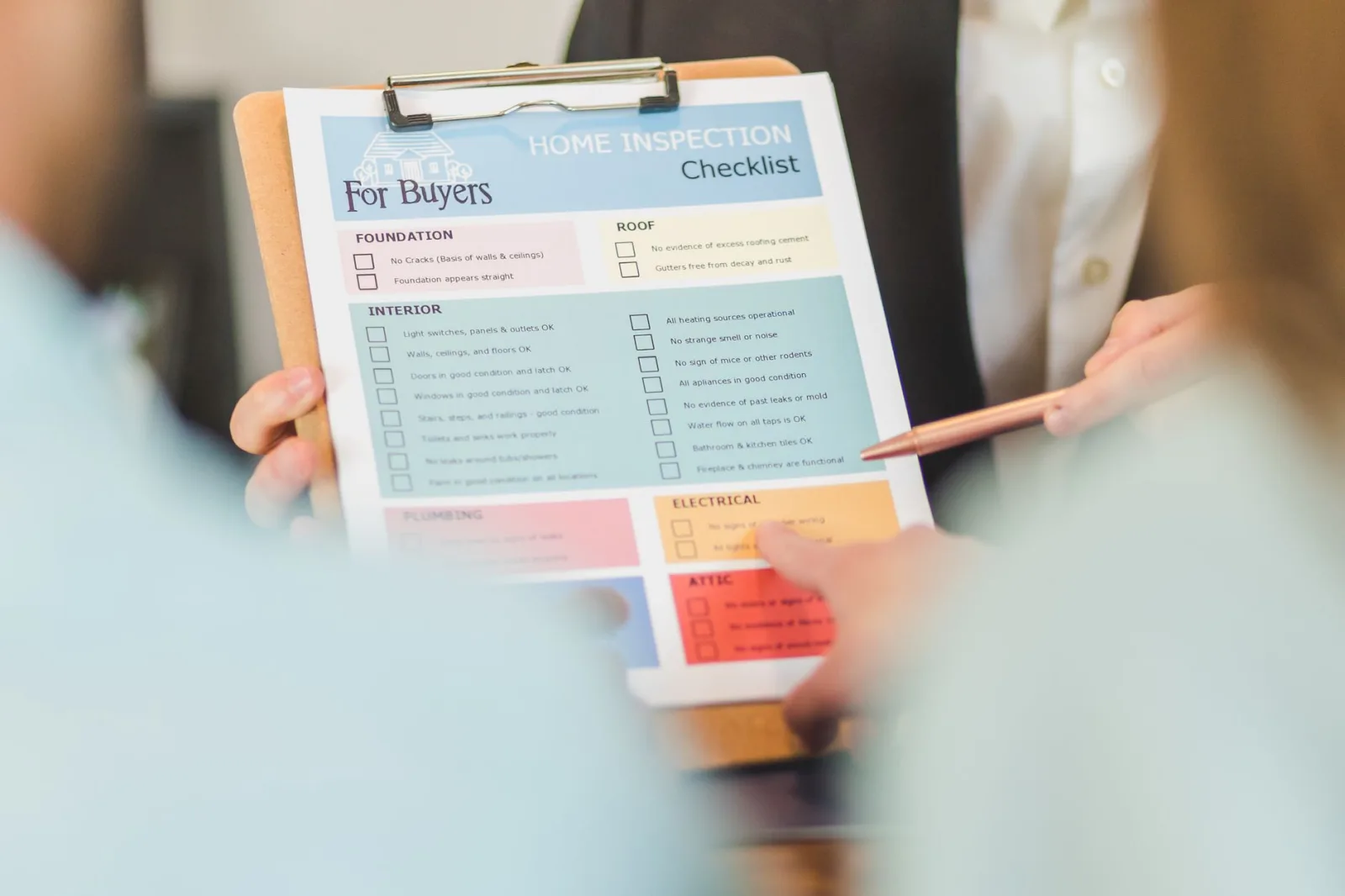 Person holding a clipboard checklist while standing on a lawn planning a mower purchase
