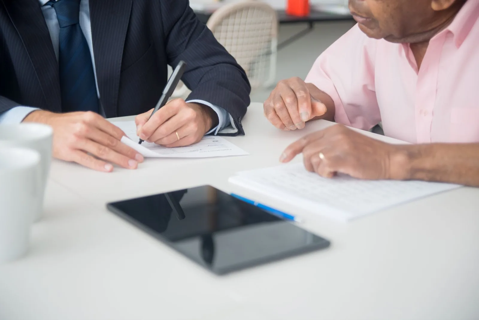 Person reviewing a finance agreement on a tablet before subscribing to a robot mower plan