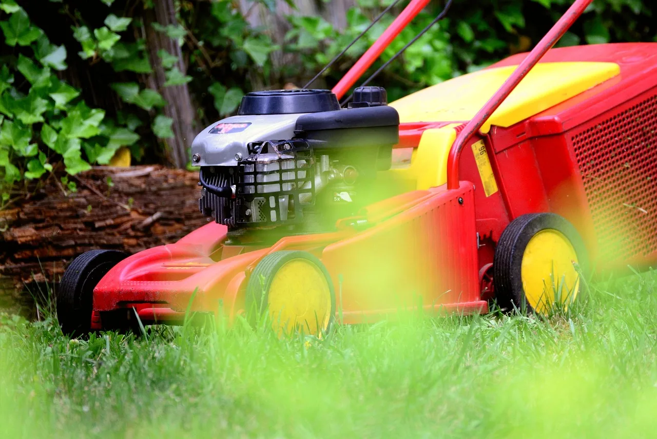 A robot mower crossing an open green lawn along an irregular navigation path