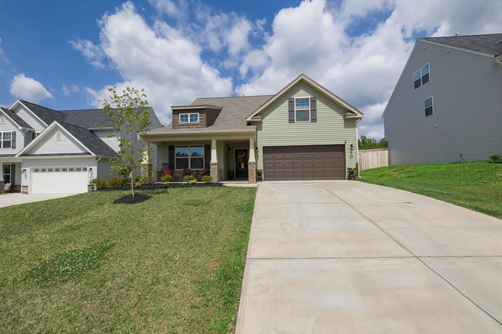 Detached front lawn separated from the backyard by a paved driveway