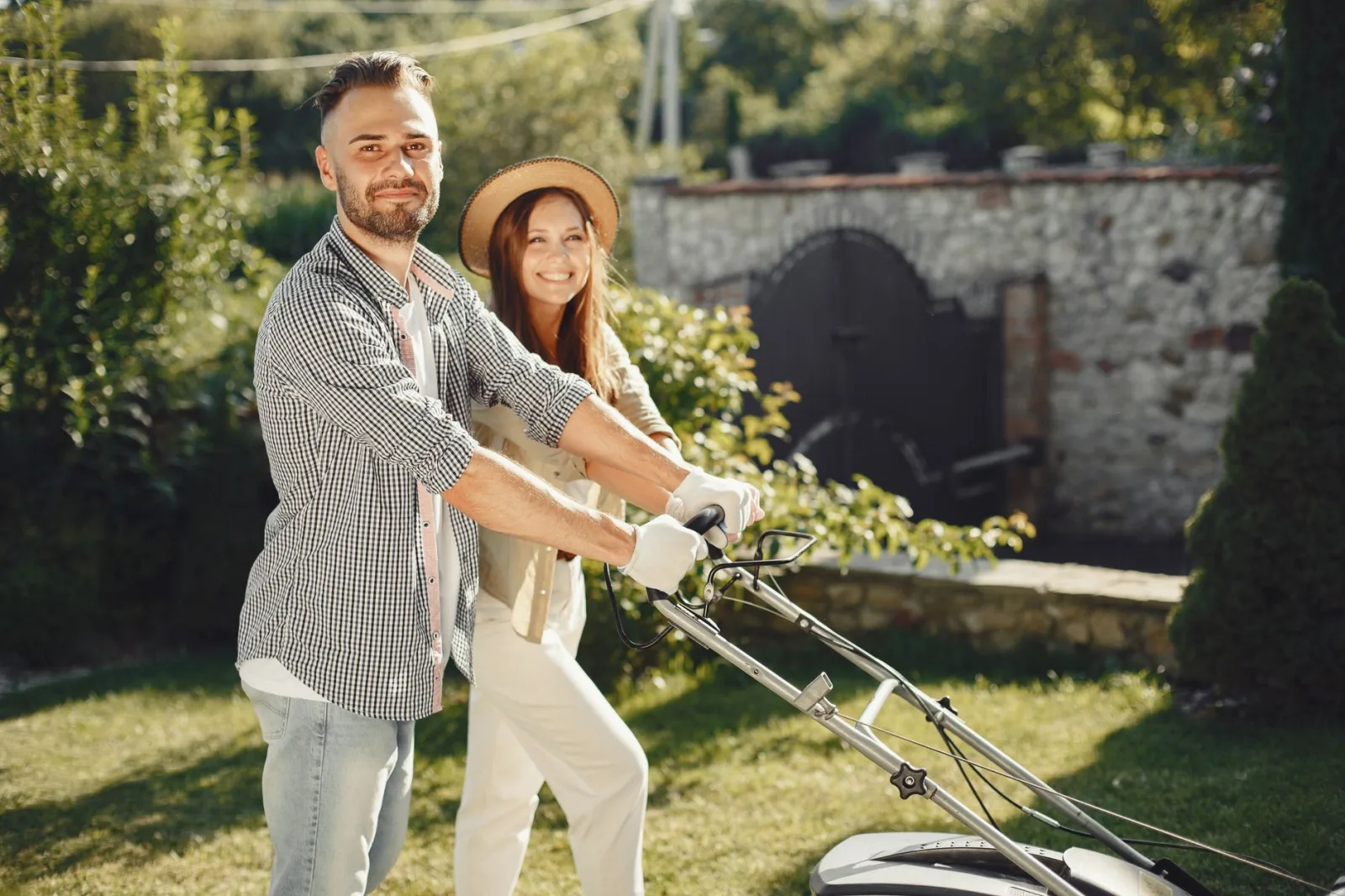 Owner watching a robot mower complete its supervised first mow on a lawn