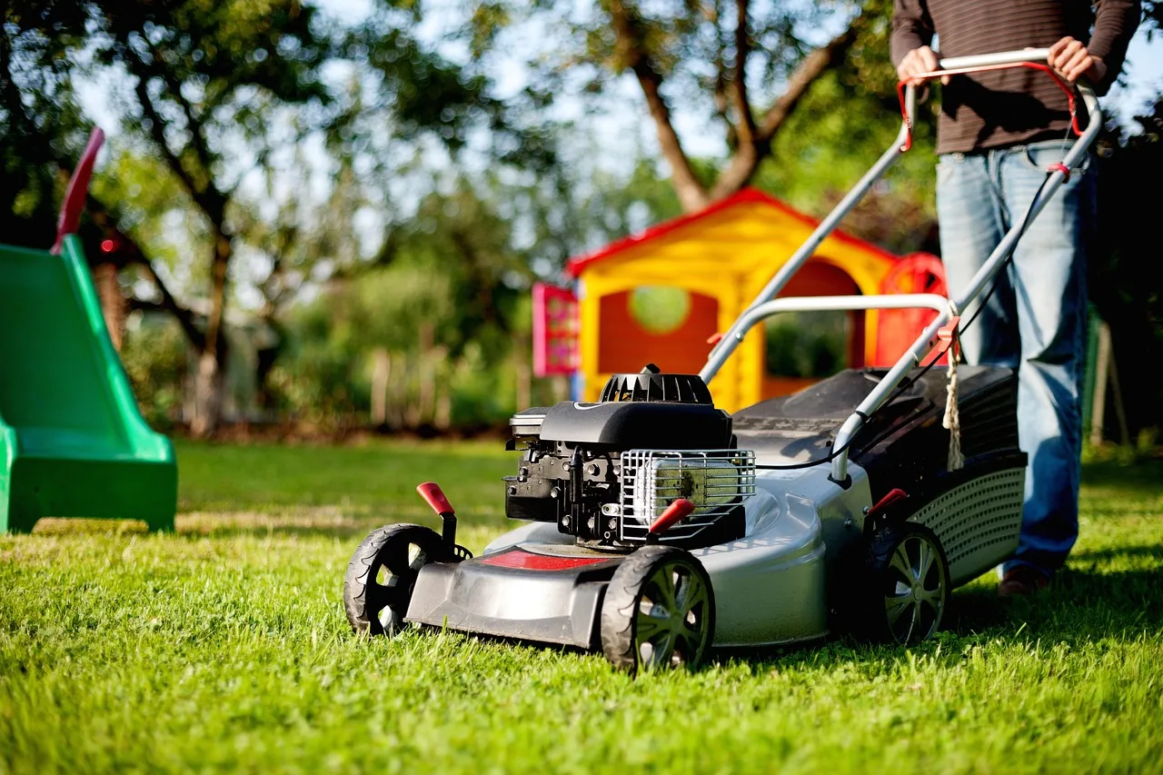 Robot mower approaching a small object left in the grass on a lawn