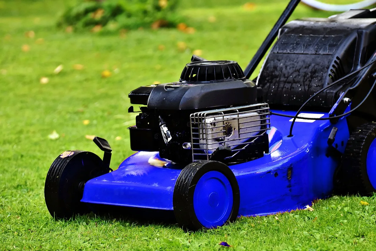 Homeowner checking a robot mower status alert on a phone app outdoors