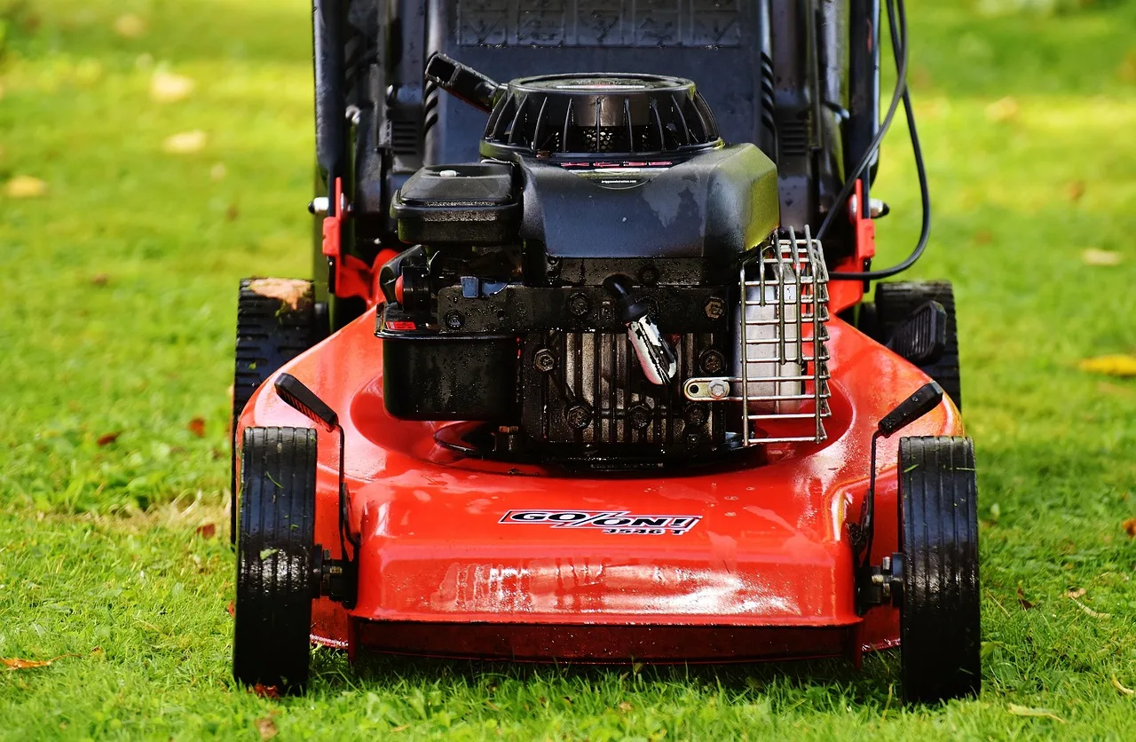 Robot mower on a uniform green lawn with no visible stripes