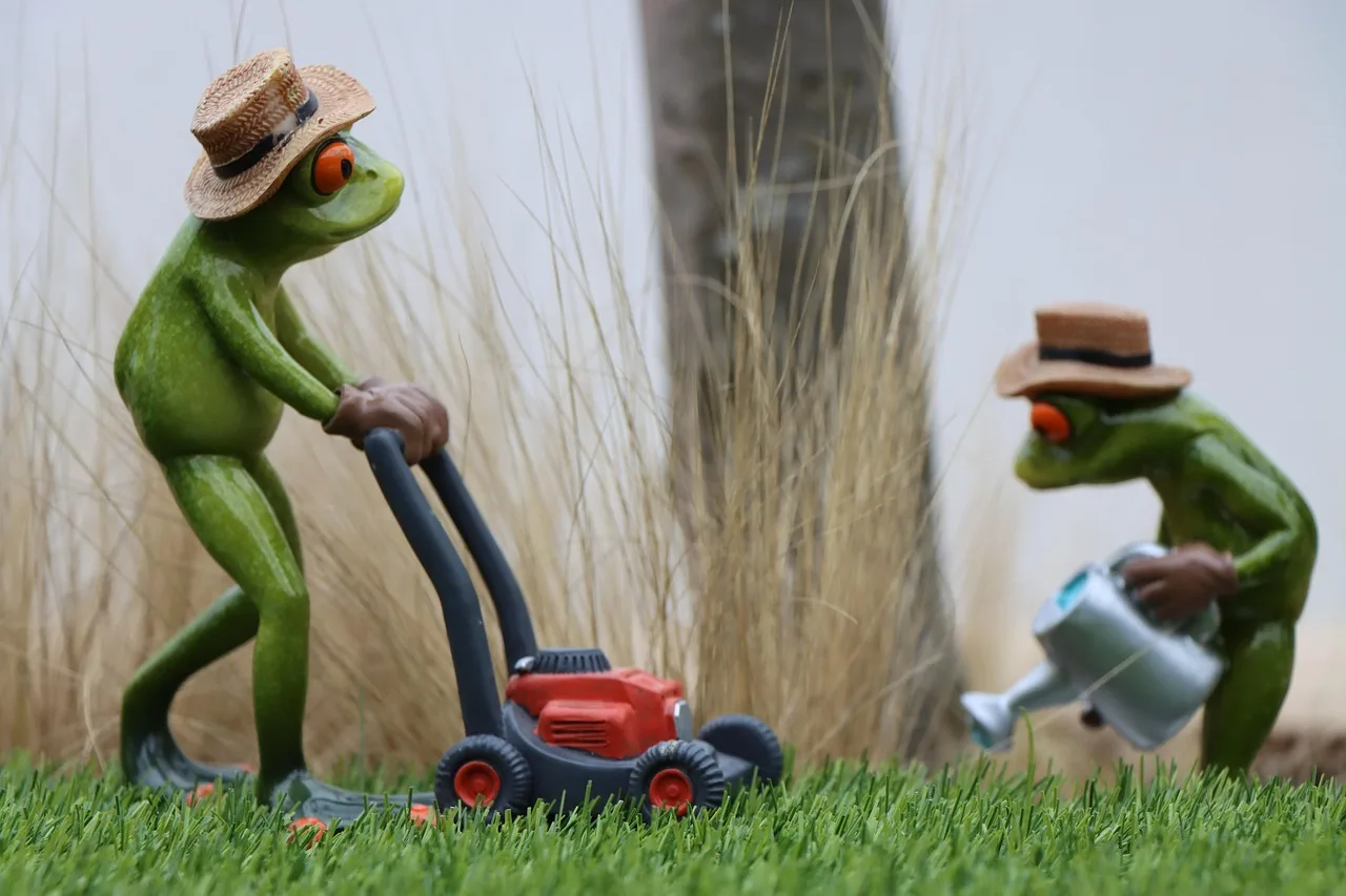 Robot mower approaching its charging station along a clear straight lawn approach